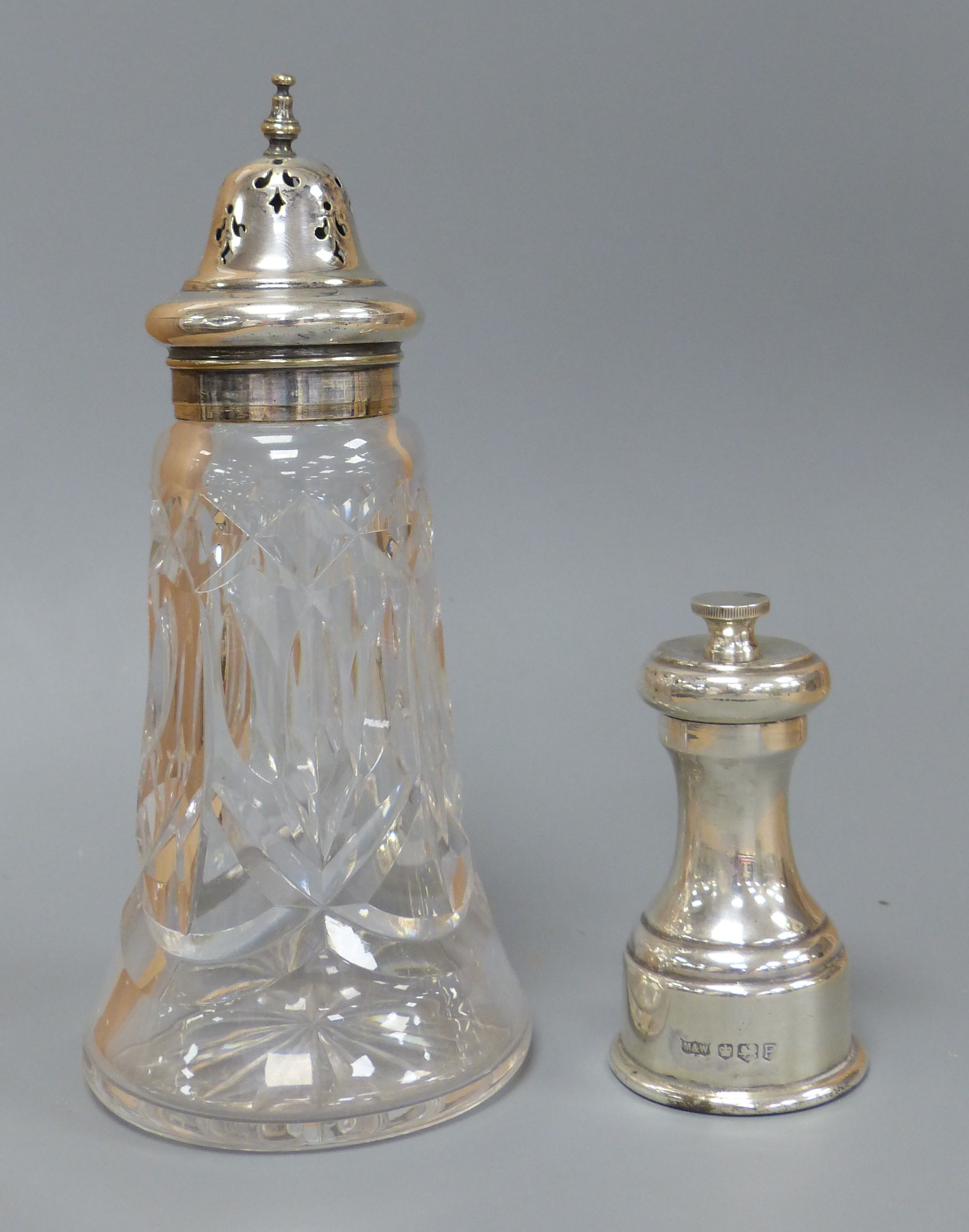 A modern silver pepper mill, Mappin & Web, Sheffield, 1957, 85mm and silver plated mounted glass sugar sifter.